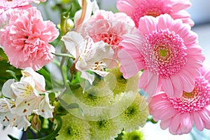 Shallow focus closeup shot of a pink bouquet of Transvaal Daisy, Lily, Rose, Peony flowers