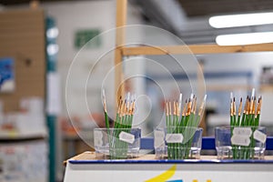 Shallow focus hobbyist paintbrushes seen within a general and hobby store.