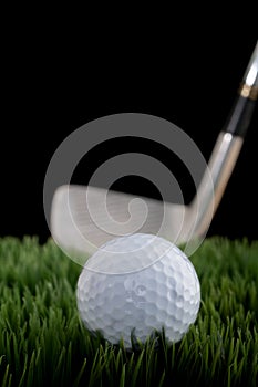 Shallow focus image of a golf ball and club