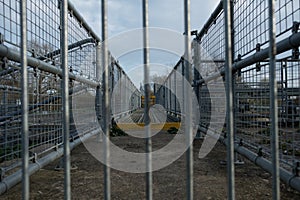 Shallow focus of locked, industrial footbridge, with detail of the fencing and non-slip footpath.