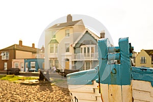 Shallow focus of an old wooden fishing boat seen on a shingle shoreline.