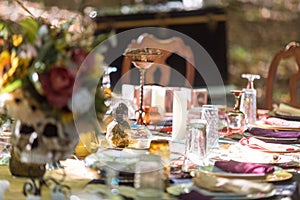 Shallow focus shot of a beautiful table setting and unique decorations at the outdoor wedding venue