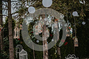 Shallow focus shot of an outdoor wedding ceremony reception hanging decorations