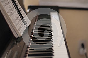 Shallow focus shot of a piano with a songbook