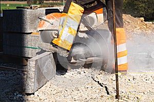 Shallow focus shot of a worker working with a stone cutting machine