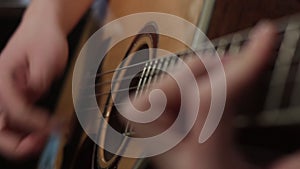 Shallow focus of the technique of the play on acoustic guitar