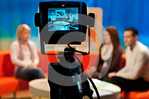 Shallow focus of a Video camera viewfinder, recording show in a TV studio during a talk show