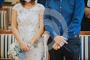 Shallow focus of a young couple getting married under the lights with a blurry background