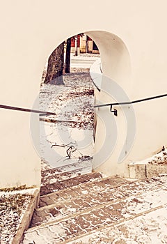 Shallow stairs and an historic gate, yellow filter