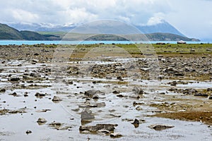 Shallow water at Lake Tekapo reveals a lot of small stones