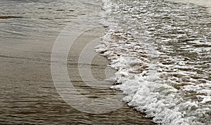 A shallow wave on sandy beach