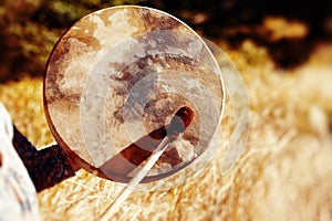 Shaman frame drum in woman hand in the nature.