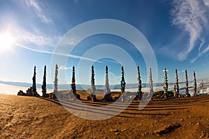 Shaman poles of serge on Olkhon in the sunset with long shadows photo