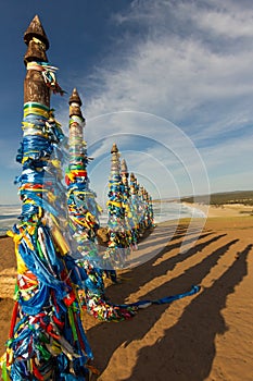 Shaman poles of serge on Olkhon in the sunset with long shadows photo