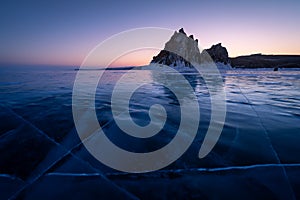 Shaman rock, sacred stone in Olkhon island in a beautiful morning sunrise, Baikal lake in winter, Russia