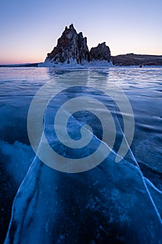 Shaman rock, sacred stone in Olkhon island in a beautiful morning sunrise, Baikal lake in winter, Russia