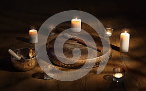 Shaman tambourine and Tibetan bowl in a dark room