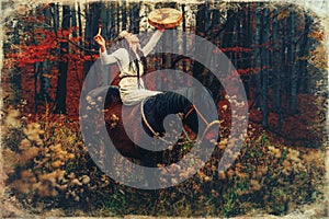 Shaman woman in autumn landscape with her horse. Old photo effect.