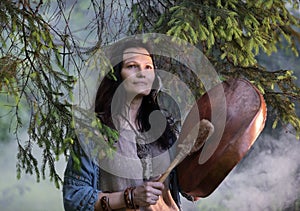 Shaman woman drumming