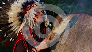 Shaman woman drumming at night in the forest