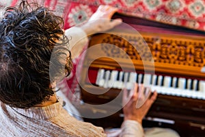 Shamanic playing kirtan music with harmonium