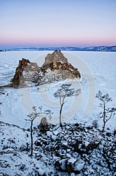 Shamanka rock in winter at sunrise. Olkhon island, Baikal lake, Siberia, Russia.