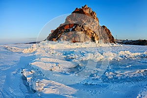 Shamanka rock in winter sunset. Olkhon island, Baikal lake, Siberia, Russia