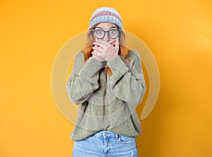 Shame. Close up beautiful young woman covering face with hands, isolated on yellow background. Oops. Ashamed girl