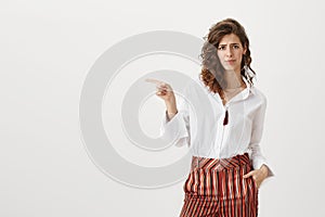 It is shame you do not use this opportunity. Studio portrait of attractive caucasian woman in trendy striped trousers