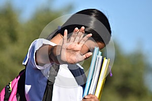 Shameful Cute Minority Person Wearing School Uniform Holding Books