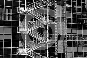 A shameful staircase running along the wall of a glass building