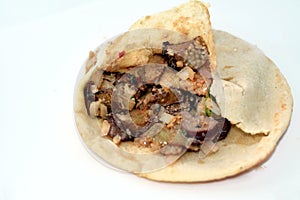 A Shami Syrian pita bread filled with traditional Egyptian Alexandrian fried eggplant aubergine with garlic and slices of olive,