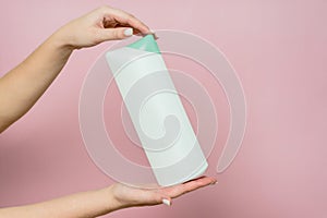 Shampoo bottle in hand. Spa beauty treatment and skin and hair care concept. Bath accessories