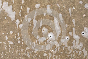 Shampoo foam on concrete floor. The texture of the wet floor covering in the yard. Bubbles and foam streaks after washing,