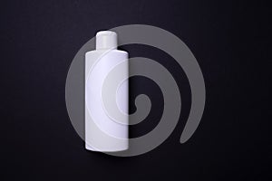 Shampoo or hair conditioner bottle isolated on black background