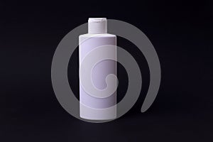 Shampoo or hair conditioner bottle isolated on black background