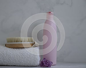 Shampoo, towel, massage brush  bath  on a colored background