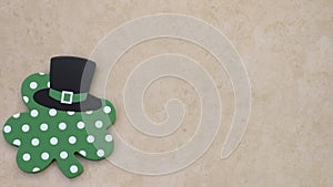 Shamrock with black top hat on a white tan background