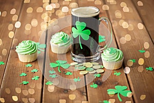 Shamrock on glass of beer, green cupcake and coins
