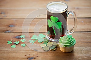 Shamrock on glass of beer, green cupcake and coins