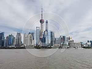 Shanghai Oriental Pearl Tower and skyscrapers the Huangpu River with cloudy sky