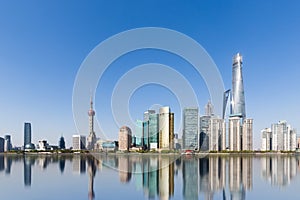 Shanghai skyline and reflection against a sunny sky