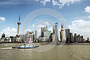 Shanghai skyline and a tugboat