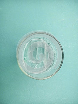 Shape of drinking glass top view isolated on aqua green background.