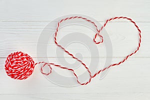 Shape of heart from red woolen thread.