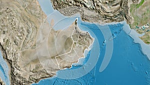 Shape of Oman with regional borders. Satellite.