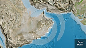 Shape of Oman with regional borders. Satellite. Labels