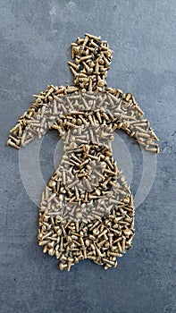 Shape of pictogram man made from brass screws