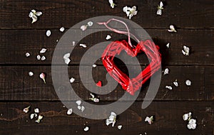 Shape of red heart as symbol of love on rustic wooden background. Greeting card for Valentine`s Day, Women`s Day and Mother`s D