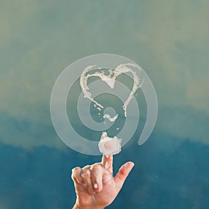 Shape of soap heart on the transparent glass door.